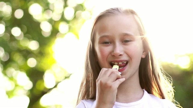 Adorable little girl licks ledinets lolly