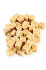 Brown sugar in spoon and bowl on wooden background