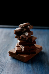 Chocolate plates tower on blue wooden background