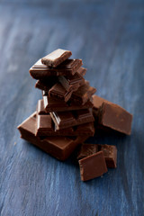 Chocolate plates tower on blue wooden background