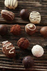 Chocolates on brown wooden background