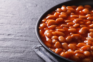 beans in tomato sauce in a black bowl 