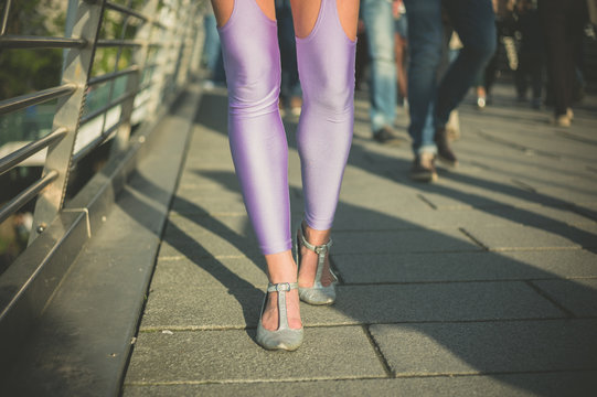 Woman in leggings walking on bridge