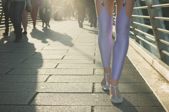 Woman in leggings walking on bridge