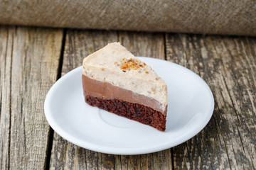 Tasty nuts cake on wooden background.