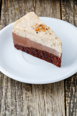 Tasty nuts cake on wooden background.