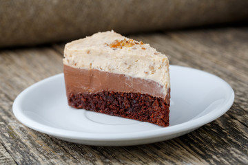 Tasty nuts cake on wooden background.