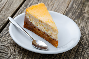 Sweet slice of carrot cake on white plate.