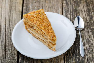 Tasty honey cake on wooden background.