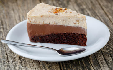 Tasty nuts cake on wooden background.