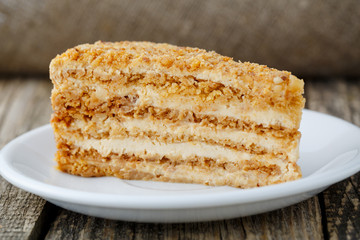 Tasty honey cake on wooden background.