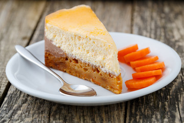 Sweet slice of carrot cake on white plate.