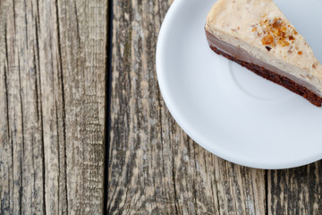 Tasty nuts cake on wooden background.