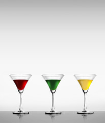 Glass of red wine, green, yellow on a white background.