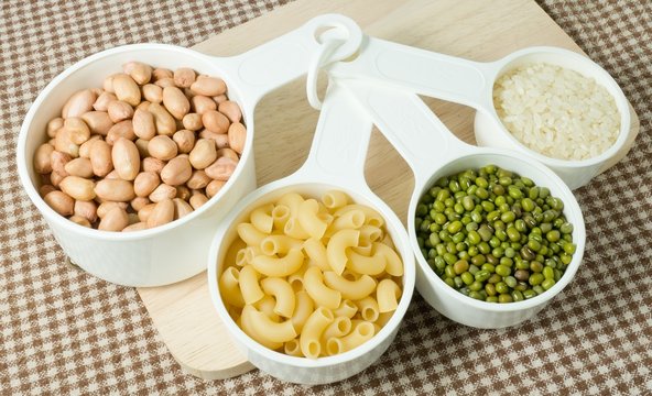Pasta, Rice, Peanuts and Mung Beans in Measuring Spoons
