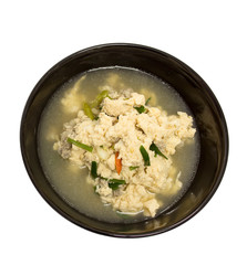 Fried Eggs in Clear Soup in black bowl on white background