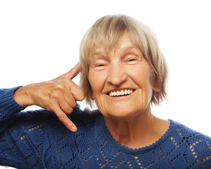 senior happy woman is making a call me gesture 
