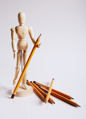 Wooden mannequin for painting with pencils on a white background