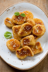 Close-up of sesame chicken nuggets on a plate, view from above