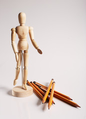Wooden mannequin for painting with pencils on a white background