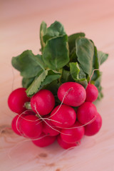 Bunch of fresh radish on vintage wooden table