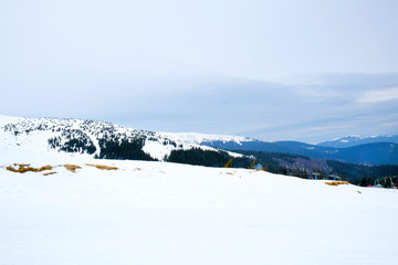 Fototapeta na wymiar Snowy mountains in wintertime