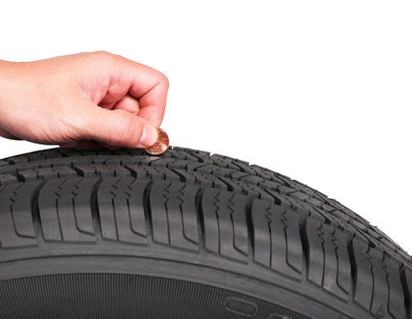 hand with american cent coin check tire condition isolated on wh