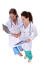 Two woman nurse watching X Ray image, standing in hospital