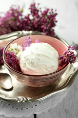 Beautiful composition with tasty ice cream and lilac flowers