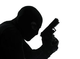 thief criminal terrorist holding gun portrait silhouette