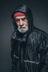Elderly Man Wearing Bonnet and Rain Slicker