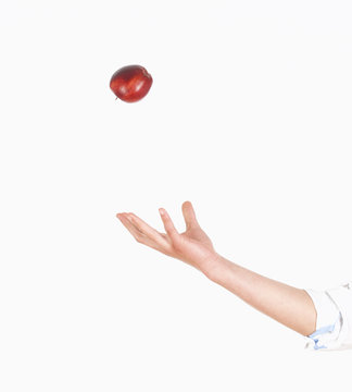 Hand Tossing Red Apple In The Air