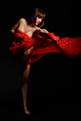 Beautiful female dancer covered with red fabric