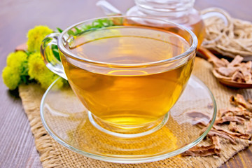 Tea of Rhodiola rosea in glass cup on board