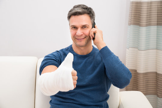 Man With Fractured Hand Showing Thumb-up