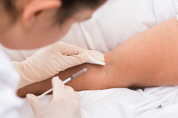 Obraz na płótnie Canvas Doctor Injecting Vaccine To Patient