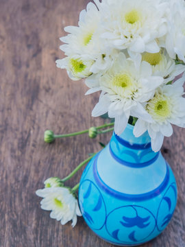 white deisy flower in colorful vase