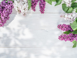 Blooming lilac flowers on the old wooden table.
