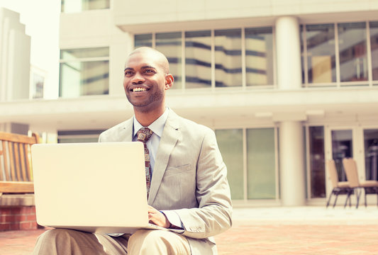 businessman working on laptop outdoors