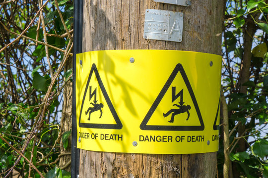 Electricity pole with warning sign
