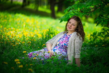 Naklejka na ściany i meble Pregnant woman in spring garden
