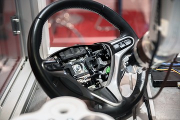 Robotic arm tearing down steering wheel