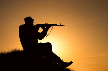 Fototapeta na wymiar silhouette of a soldier with a gun
