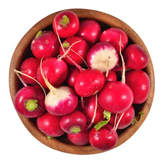Red radish in a wooden bowl on a white