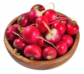 Red radish in a wooden bowl on a white