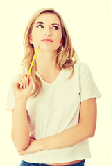 Thoughtful woman with pencil