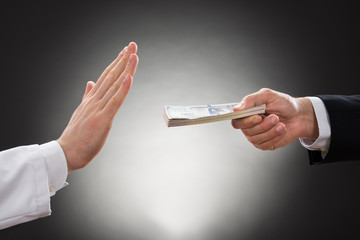 Businessman Offering Bribe To Doctor
