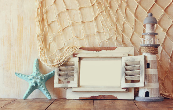 old vintage wooden white fram, starfish and lighthouse