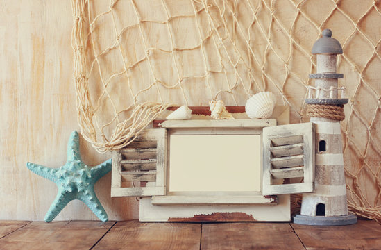 old vintage wooden white fram, starfish and lighthouse