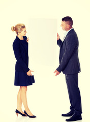 Couple holding a poster together